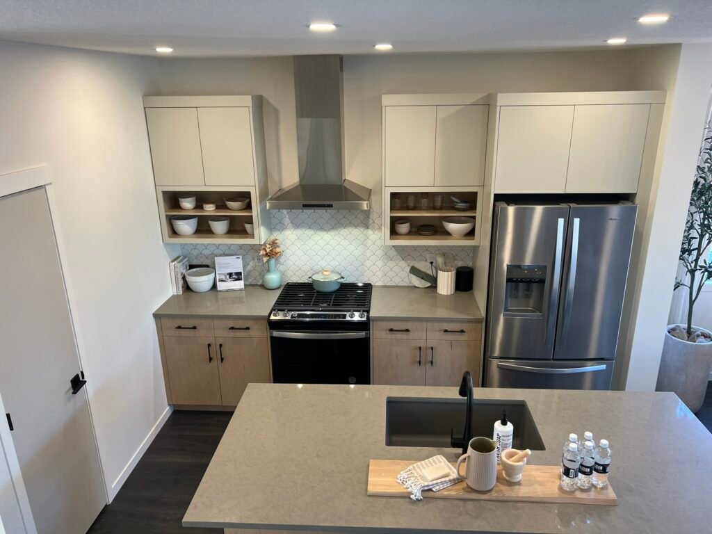 White and light wood kitchen with natural accents and quartz countertop – custom design by Coldii Inc. in Calgary